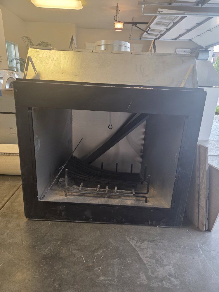 Used Fireplace Insert with Log Grate and Faux Brick Backing