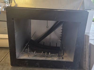 Used Fireplace Insert with Log Grate and Faux Brick Backing