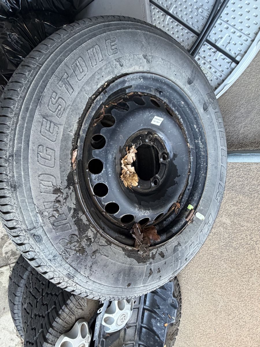 Bridgestone Dueler tire mounted on a steel rim.