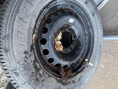 Bridgestone Dueler tire mounted on a steel rim.