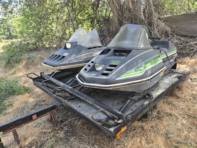 Two snowmobiles with trailer