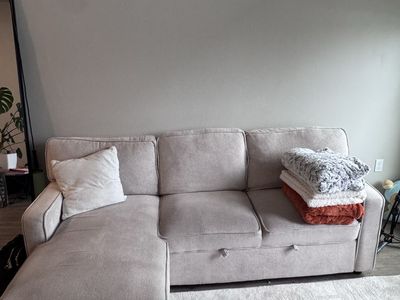 L couch, pull out couch. With storage