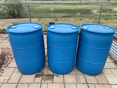 Three 55-gallon water drums