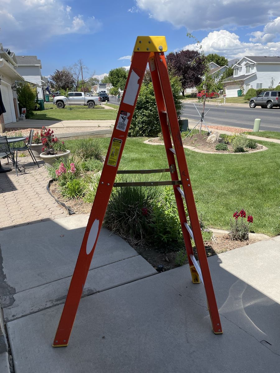 Located in West Jordan - Werner 6-Foot Orange Fiberglass Step Ladder - Heavy Duty