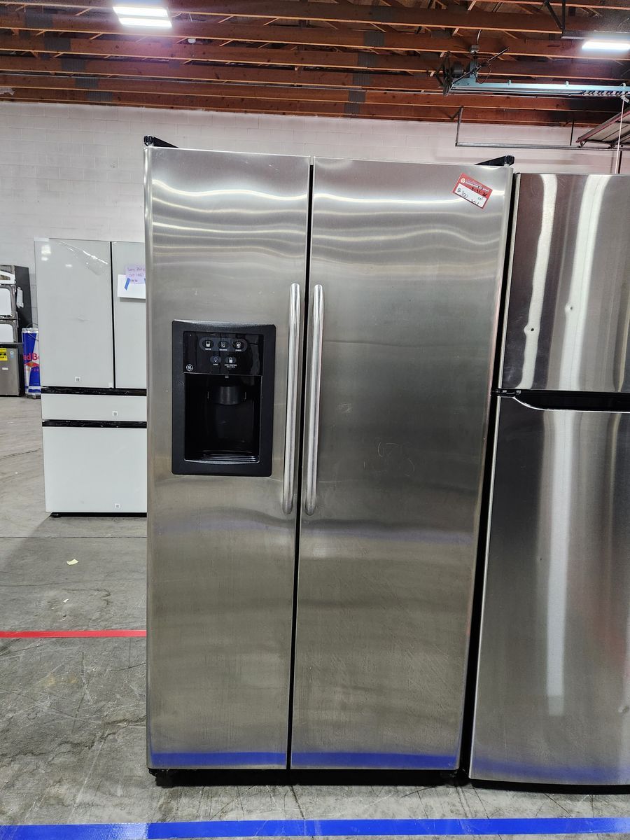NICE GE STAINLESS STEEL SIDE BY SIDE FRIDGE! WITH A FULL WARRANTY