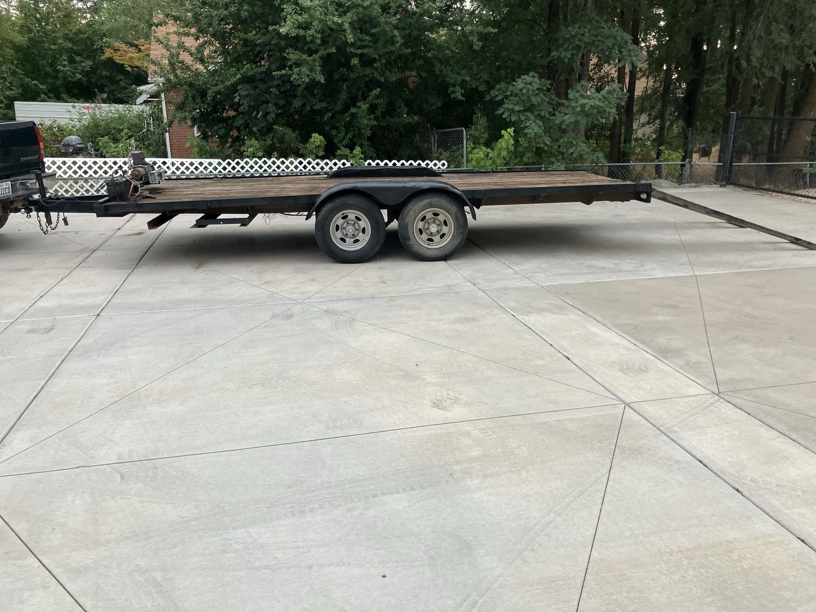 Heavy-Duty Dual-Axle Flatbed Trailer with Ramps and Winch
