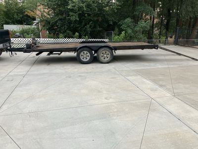 Heavy-Duty Dual-Axle Flatbed Trailer with Ramps and Winch