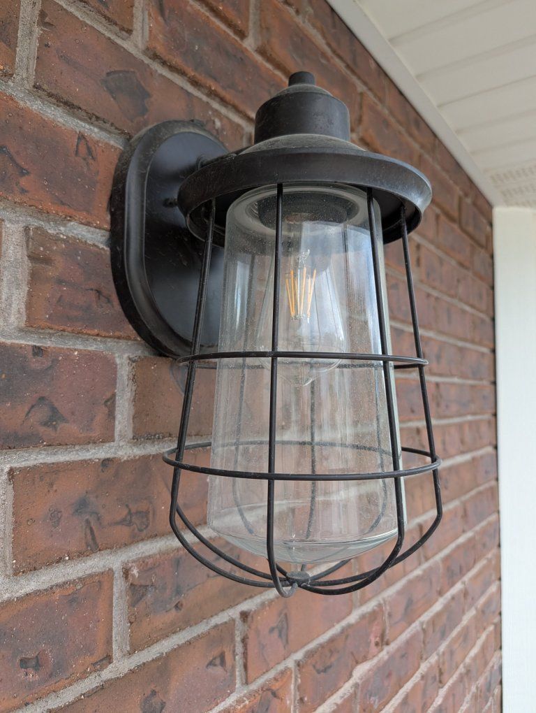 Black Outdoor Wall Sconce Light Fixture with Metal Cage and Clear Glass Shade