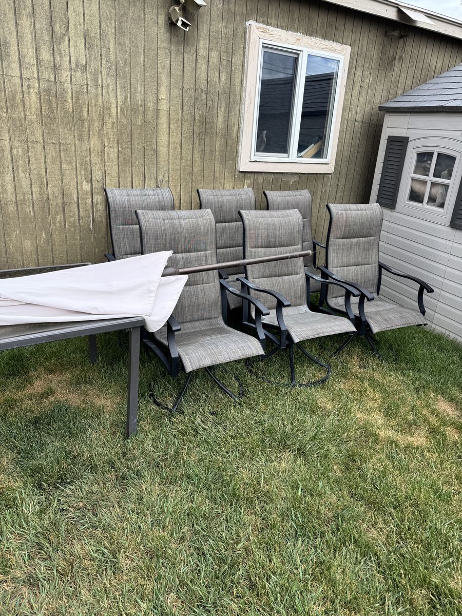 8-piece patio dining set- glass table, 6 swivel chairs & umbrella