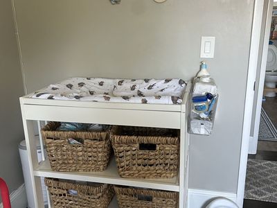 White Wood Baby Changing Table with Storage Baskets, changing pad+ cover, and Diaper Caddy - great condition