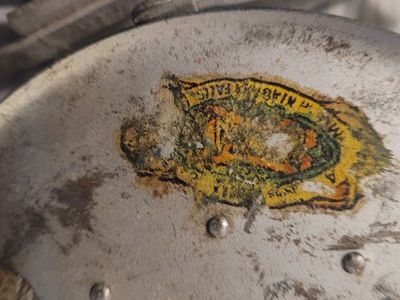 Vintage Metal Fishing Reel with Worn Label - Used Condition