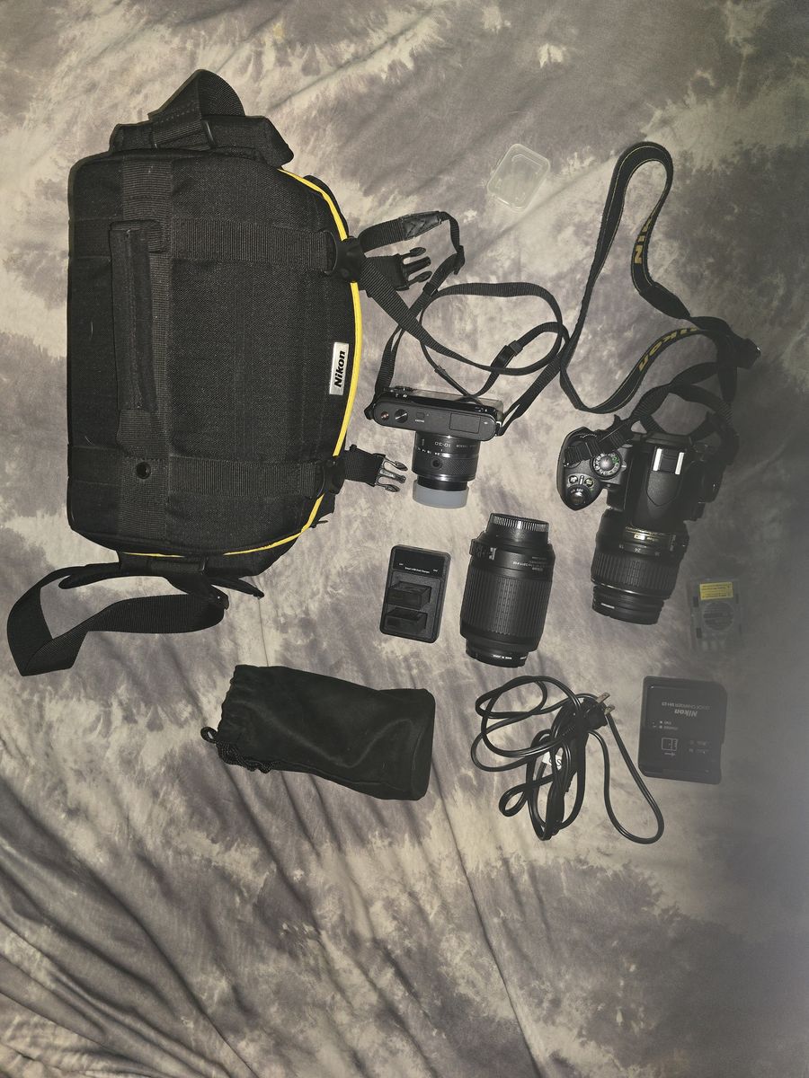 Nikon 1 J1 with 10-30 mm lens and Nikon D-40x with two lens