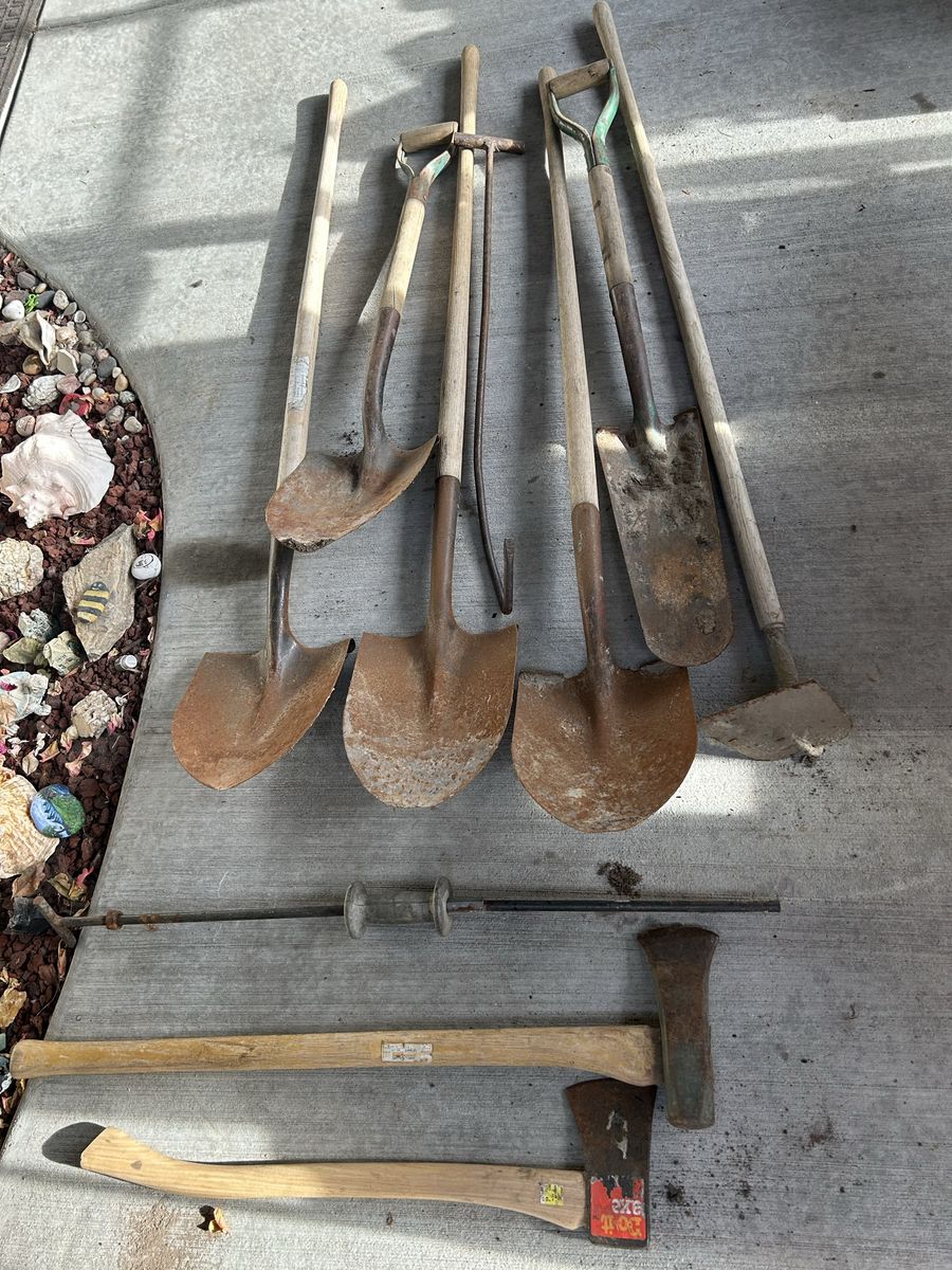 Lot of Garden Hand Tools; 5 Shovels, Hoe, Two Axes, Milk Crates Pull Hook, All Have Wood Handles & In Fair Condition