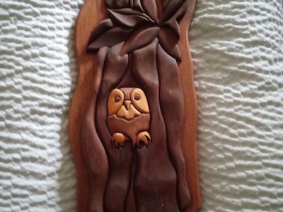 Folk art vintage wood owl in a tree