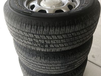 Four 265/70 R17 tires mounted on steel rims