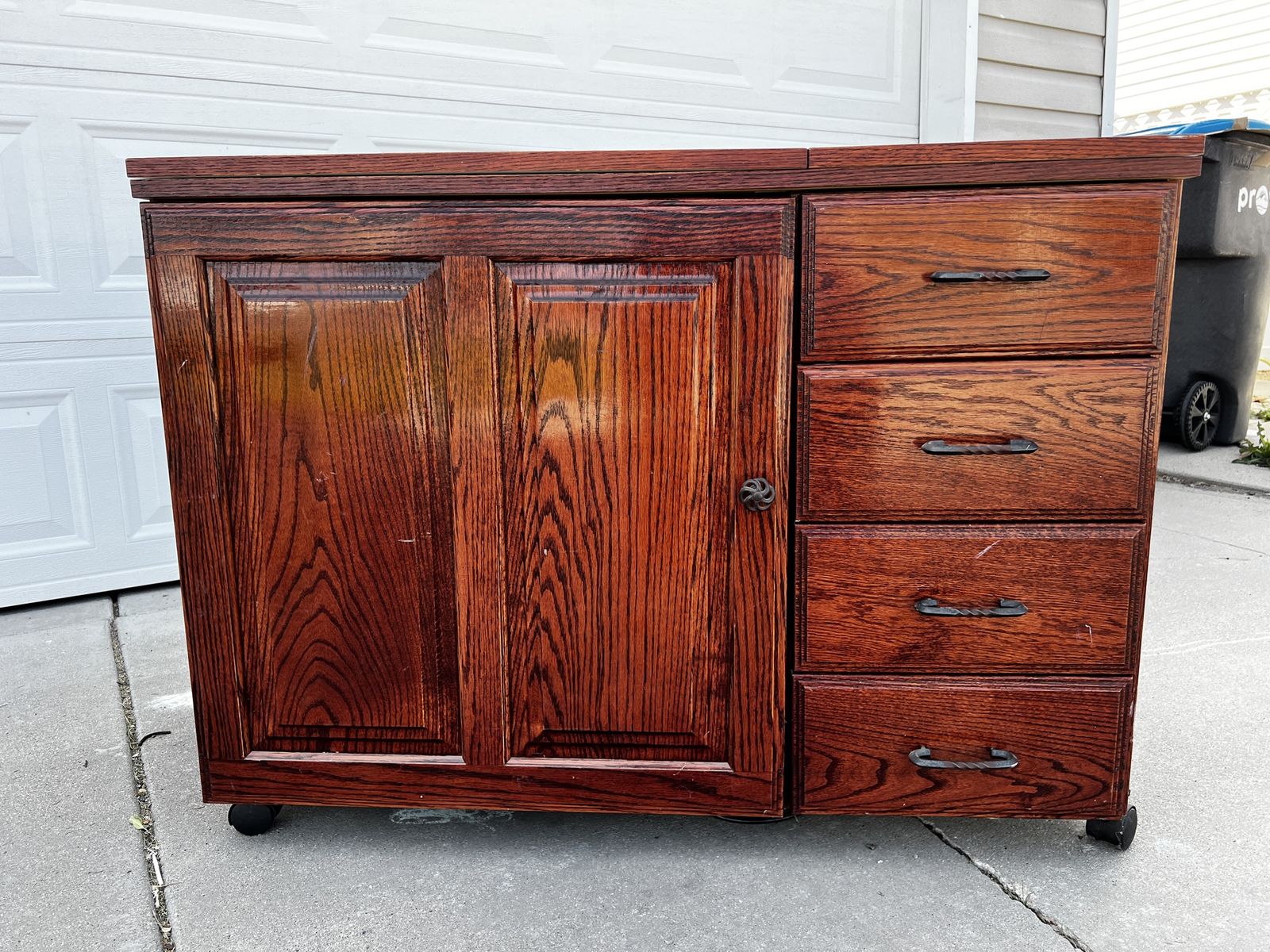 Cherry wood sewing cabinet with electric lift and drawers