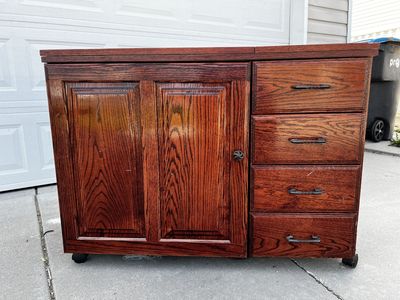 Cherry wood sewing cabinet with electric lift and drawers