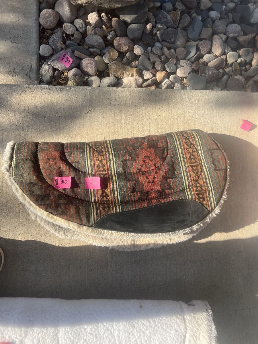 For sale, sheepskin style saddle pads in good condition with some wear.