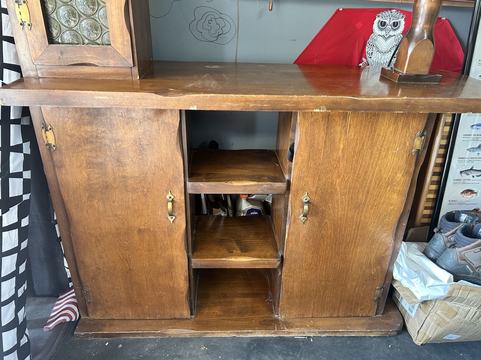 Vintage maple wood hutch features a top cabinet with glass paneling and lower storage cabinets.