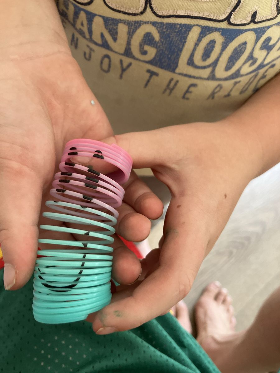 Pink & Blue Plastic Slinky Spring Toy with Drawn Faces