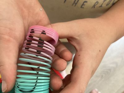 Pink & Blue Plastic Slinky Spring Toy with Drawn Faces