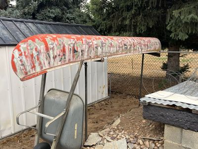 Used Canoe - Red with Camo Paint - Ready for Water Sports Adventure ,14 ft with paddles, interior never see’s the sun