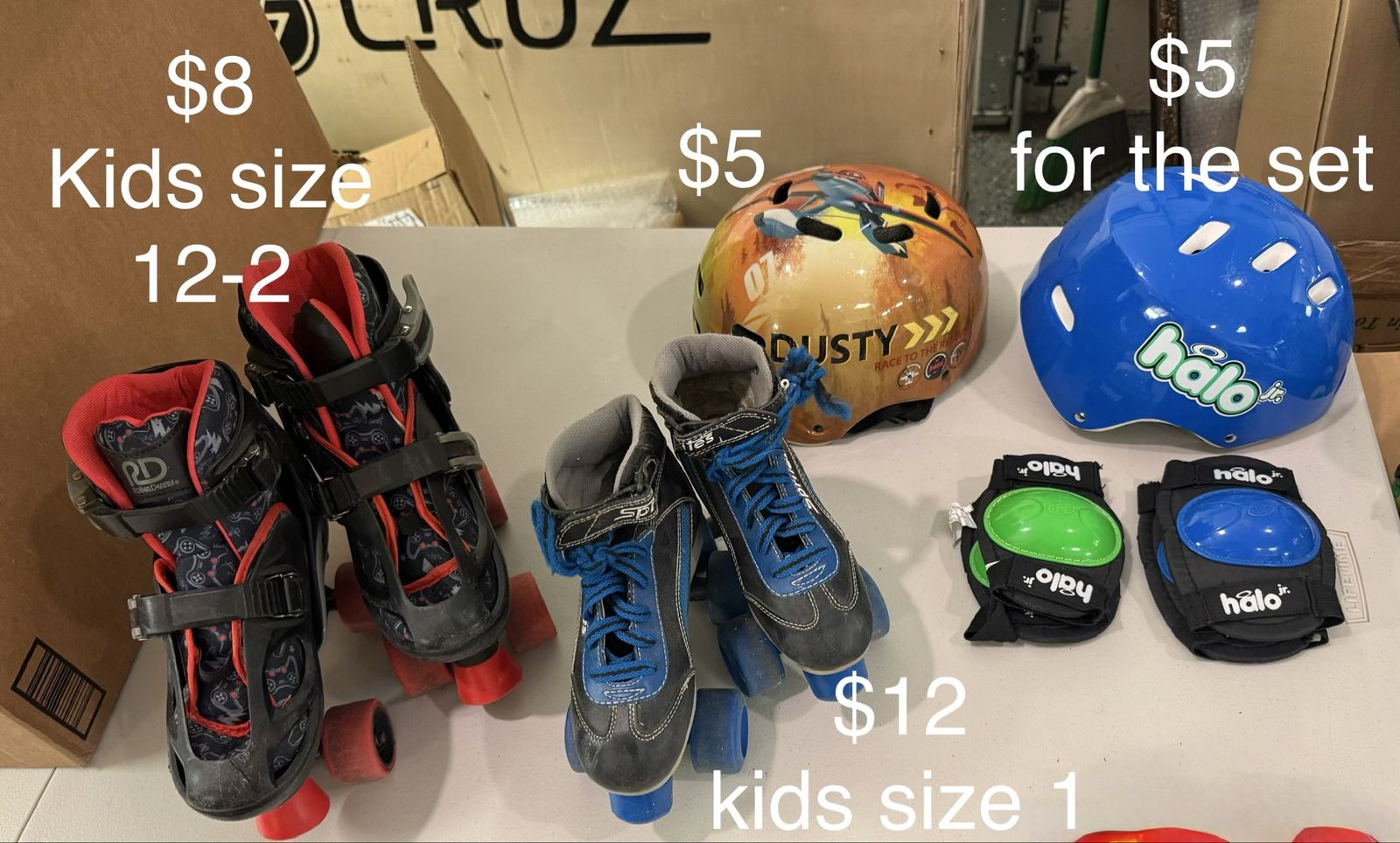 Different sized roller skates, helmets, knee, and elbow pads