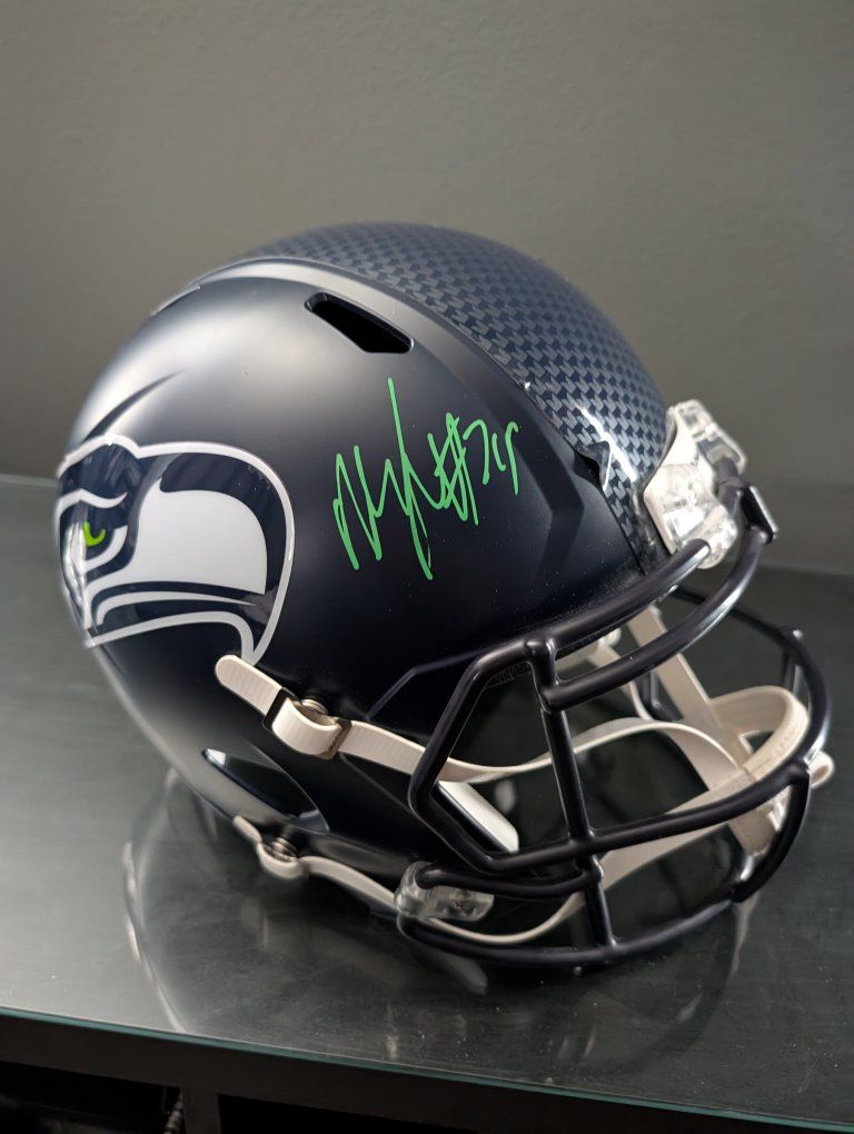 Marshawn Lynch singed full size replica helmet.