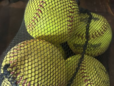 13 Used Practice Softballs - Yellow with Red Stitching, in Mesh Bag
