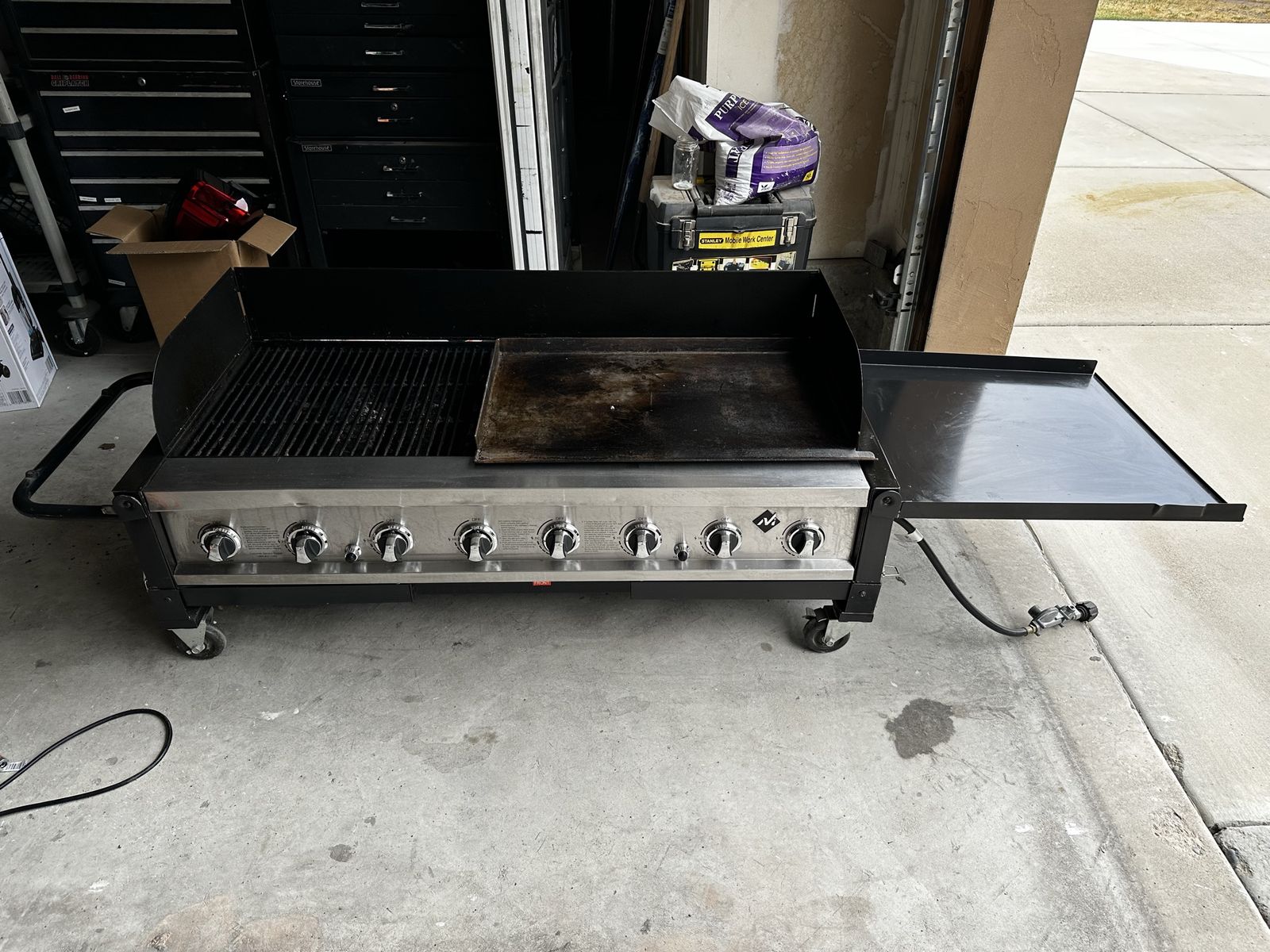 Eight burner grill with flat top. $250