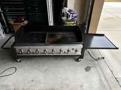 Eight burner grill with flat top. $250