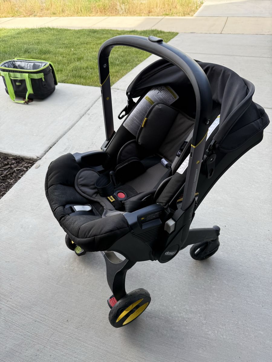 Doona Car Seat & Stroller Travel System + LATCH Base + Padded Travel Bag