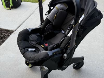 Doona Car Seat & Stroller Travel System + LATCH Base + Padded Travel Bag
