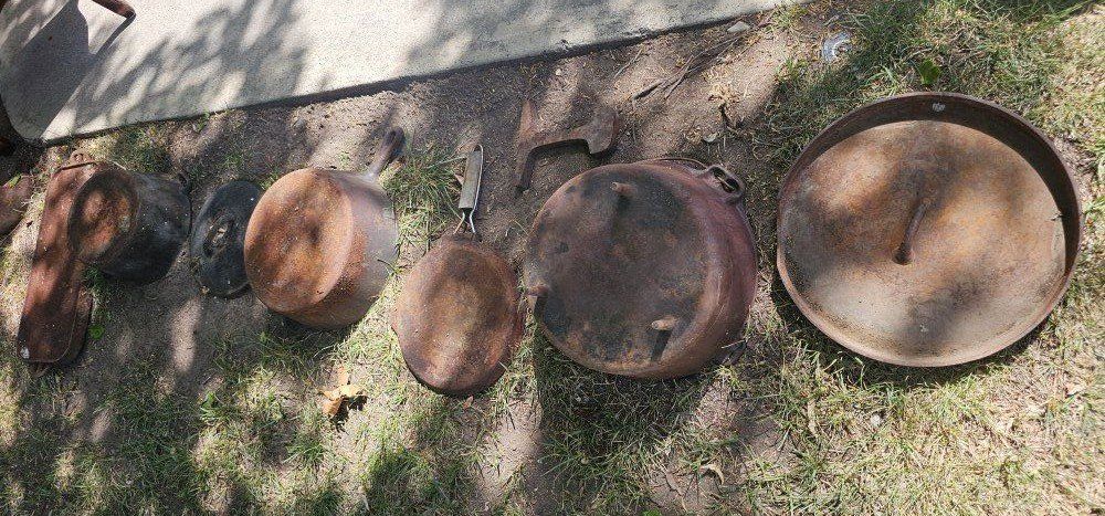 Rusty cast iron pans and likely Asian