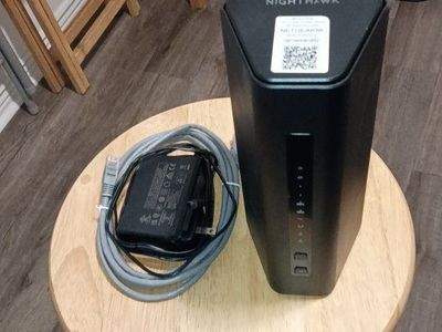 Netgear Nighthawk BE9300 Wi-Fi 7 Cable Modem Wi-Fi Router Combo with Power Supply and Ethernet Cable.
