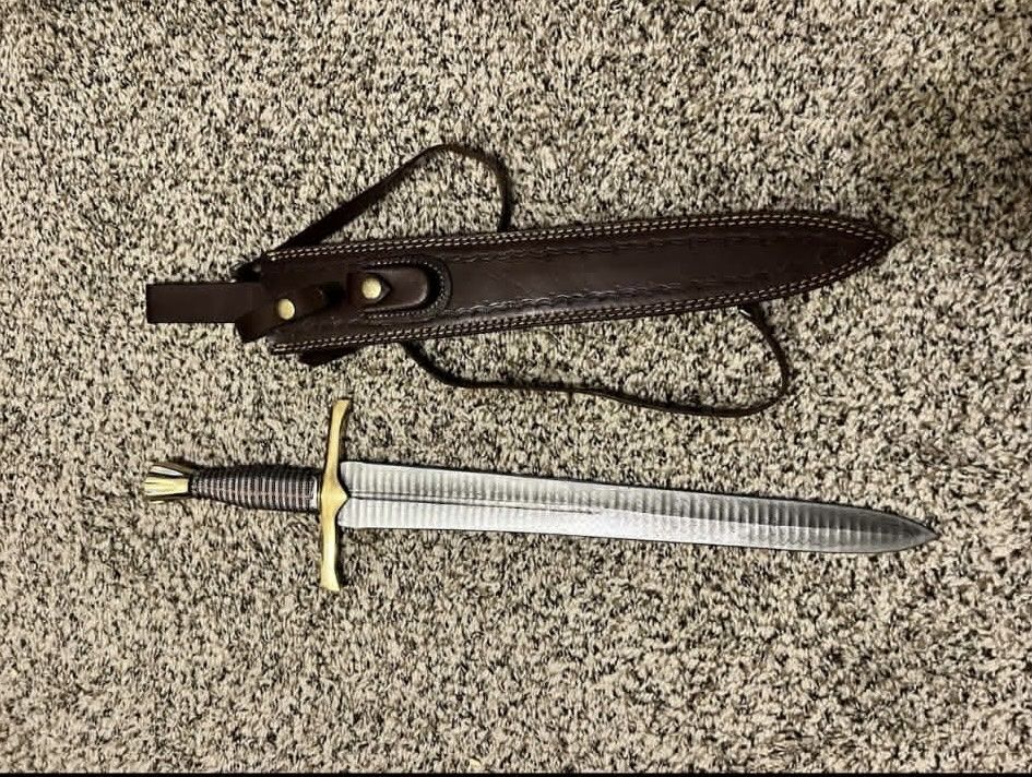 Short sword with leather sheath and strap