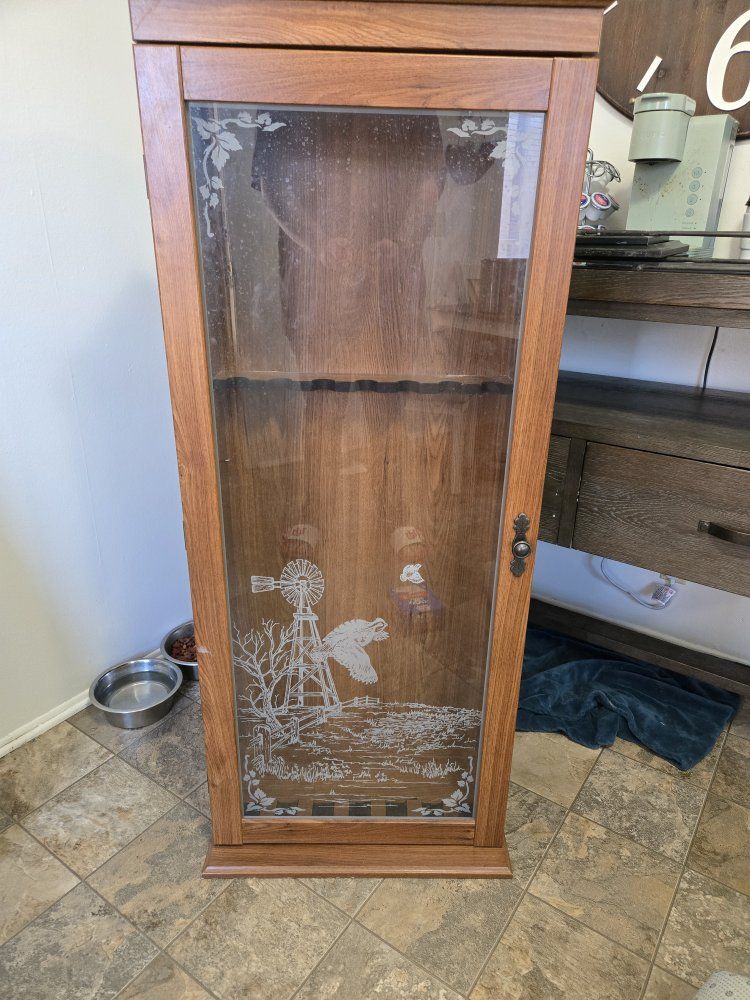 wooden gun cabinet with glass door