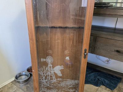 wooden gun cabinet with glass door