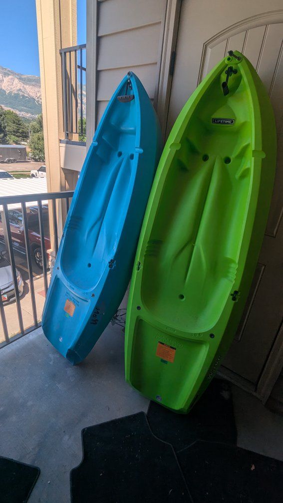 2 Lifetime Youth Kayaks (Blue & Green) with 2 Youth Life Vests and oars.