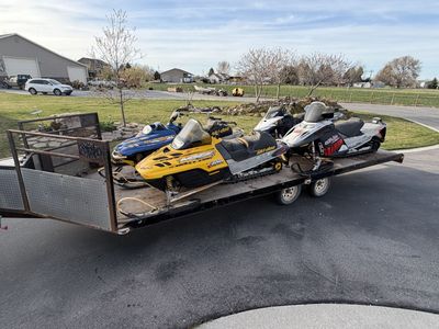 4 snowmobiles And Trailer