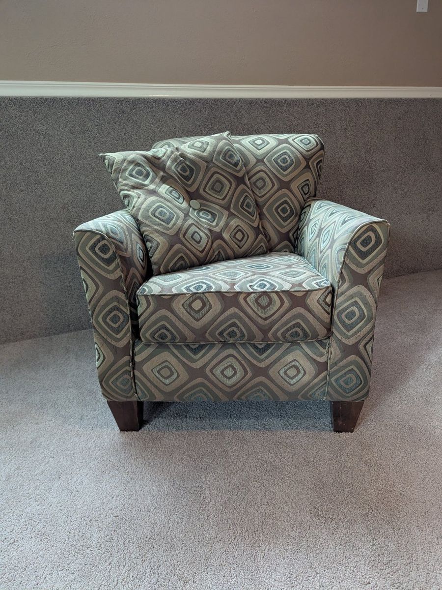 Used brown patterned armchair and pillow