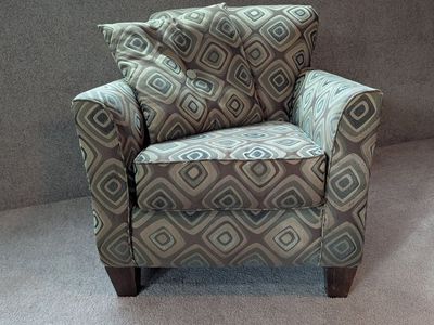 Used brown patterned armchair and pillow