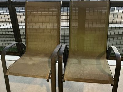 2 Used stackable patio chairs. Dark Green