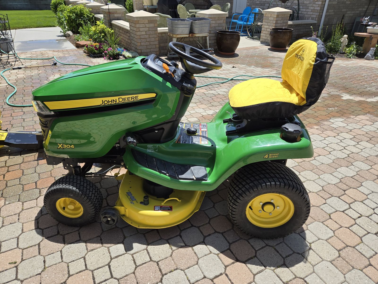 John Deere X304 and attachments 4 wheel steering. 458 hours