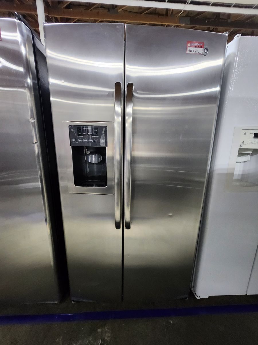 NICE GE STAINLESS STEEL SIDE BY SIDE FRIDGE! WITH A FULL WARRANTY