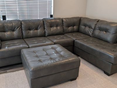 Grey L-Shaped sofa + ottoman from Ashley Furniture