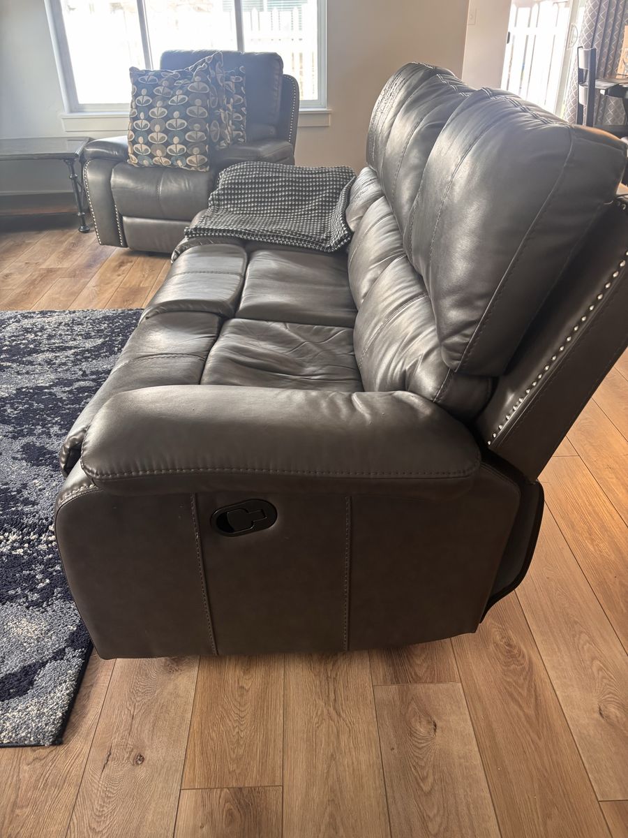 Leather/vinyl reclining sofa and dark gray