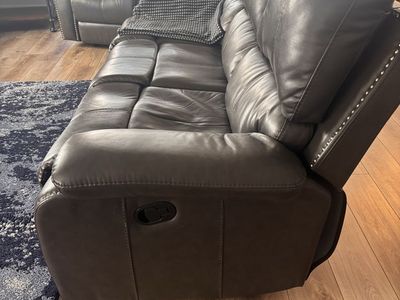 Leather/vinyl reclining sofa and dark gray