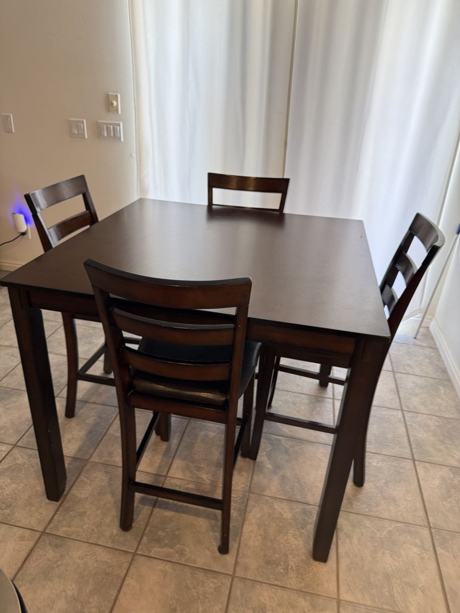 Dining table and 4 chairs located counter height