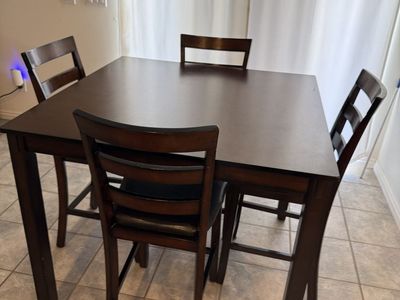 Dining table and 4 chairs located counter height